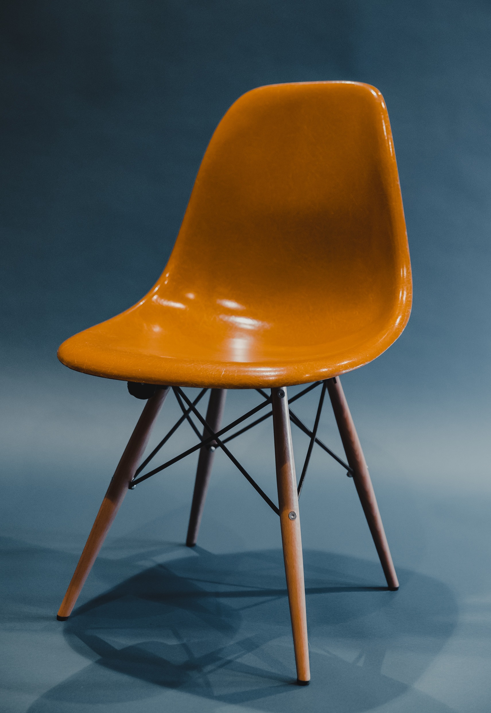 a yellow IKEA style chair on a blue background.