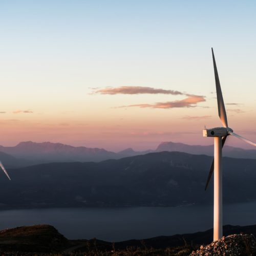Windfarm at dusk over the mountains