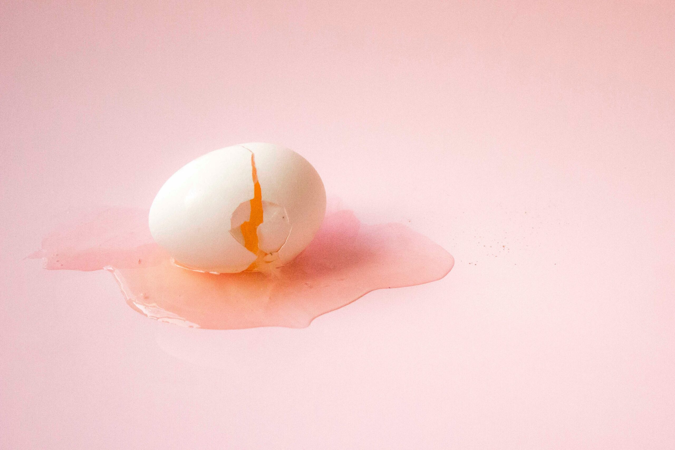 Cracked egg on pink floor - digital transformation resistance